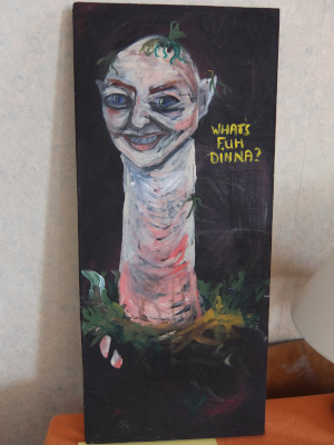 A painting of a worm with a human face asking "WHAT'S FUH DINNA?"